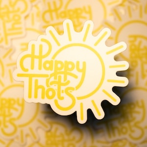 May include: Yellow sticker with a sun design and the text "Happy Thots" in a stylized font.