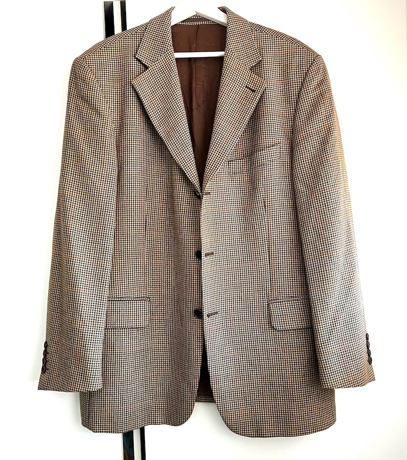 May include: A brown and beige patterned blazer with a single button closure. The blazer has a classic fit and a notched lapel.
