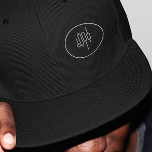 May include: A black baseball cap with a white embroidered logo of a stylized candlestick chart in an oval.