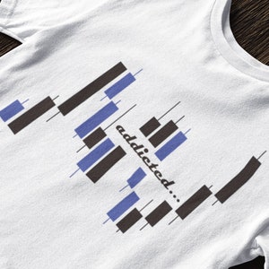 May include: White t-shirt with a graphic of a candlestick chart and the text "addicted..." printed on it.