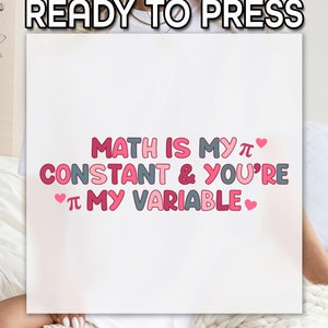 May include: A white t-shirt with the text "Math is my π constant & you're π my variable" in pink and gray letters with pink hearts.