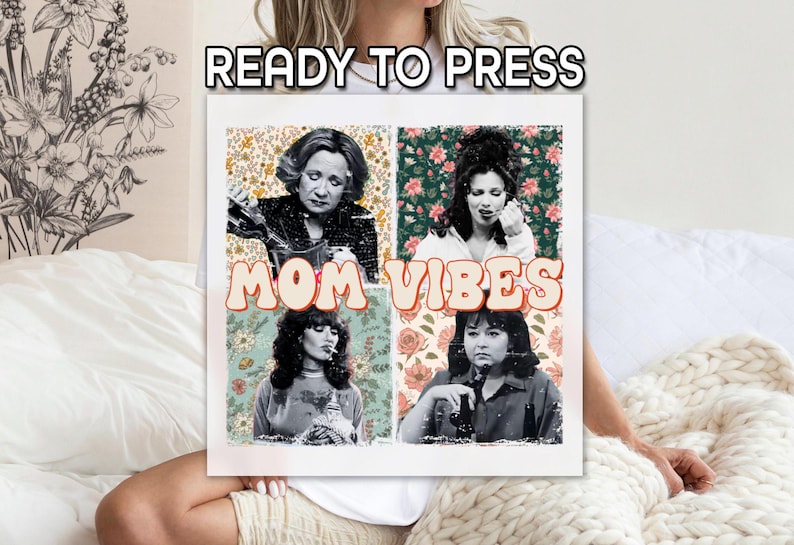 May include: A white t-shirt with a collage of four women's faces and floral patterns. The text "MOM VIBES" is printed in a retro font.