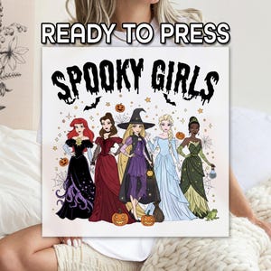 May include: A square canvas print featuring the text "READY TO PRESS" at the top and "SPOOKY GIRLS" in a spooky font. The image depicts five cartoon princesses in Halloween costumes, with pumpkins and bats.