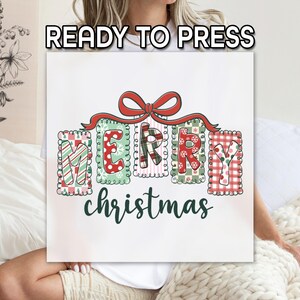 May include: A white square with the words "READY TO PRESS" at the top. The image features the words "MERRY christmas" in a festive design. The letters are in individual frames with various patterns, including stripes and polka dots, and a red bow.