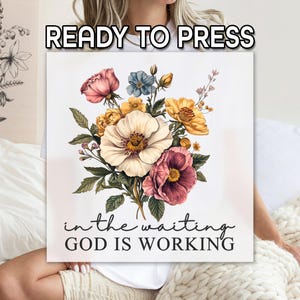 May include: A square canvas print with a watercolor floral design. The bouquet features pink, yellow, and white flowers with green leaves. The text "READY TO PRESS" is at the top, and "in the waiting GOD IS WORKING" is at the bottom.