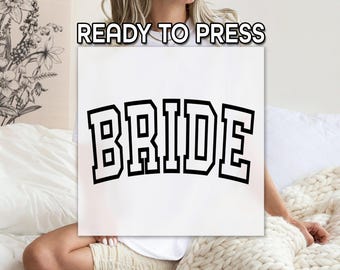 May include: White t-shirt with the word "BRIDE" printed in black block letters. The text is in a varsity style font.