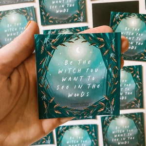 May include: A green and gold illustrated card with the text "Be the Witch you want to see in the woods".
