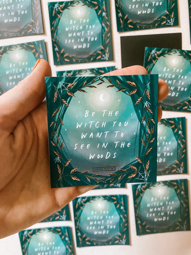 May include: A green and gold illustrated card with the text "Be the Witch you want to see in the woods".