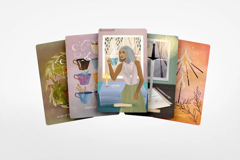 May include: Five tarot cards are fanned out, each with unique illustrations. One card depicts a woman holding a teacup, another shows teacups with plants, and others feature a sword, candles, and floral designs. The cards have a soft, watercolor style.