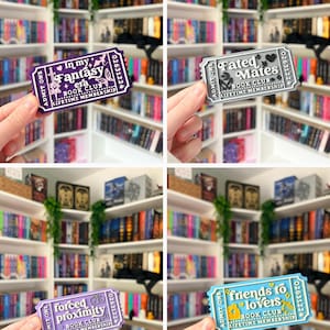 May include: Four rectangular ticket-shaped items featuring book club themes. The purple ticket reads In my Fantasy era, the silver ticket reads Fated Mates, the light purple ticket reads forced proximity, and the blue ticket reads friends to lovers.