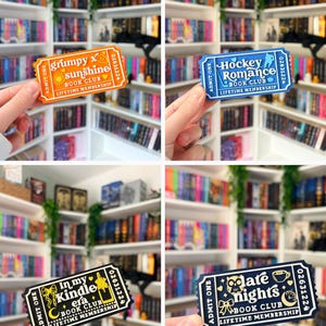 May include: Four rectangular admission tickets with rounded corners, featuring book club themes. Colors include orange, blue, black, and dark blue with white text. Each ticket displays 'ADMIT ONE', a unique title, and 'LIFETIME MEMBERSHIP'.