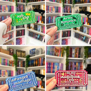 May include: A collection of four rectangular ticket-shaped stickers. One is green with 'age gap BOOK CLUB', one is green with 'Army Romance BOOK CLUB', one is blue with 'arranged marriage BOOK CLUB', and one is pink with 'In my Audiobook era BOOK CLUB'.