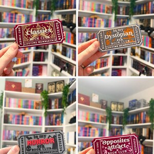 May include: Four rectangular stickers shaped like admission tickets. One is maroon with gold text reading Classies Book Club. One is grey with orange text reading In my Dystopian era Book Club. One is grey with red text reading In my Horror era Book Club. One is maroon with white text reading Opposites attract Book Club.