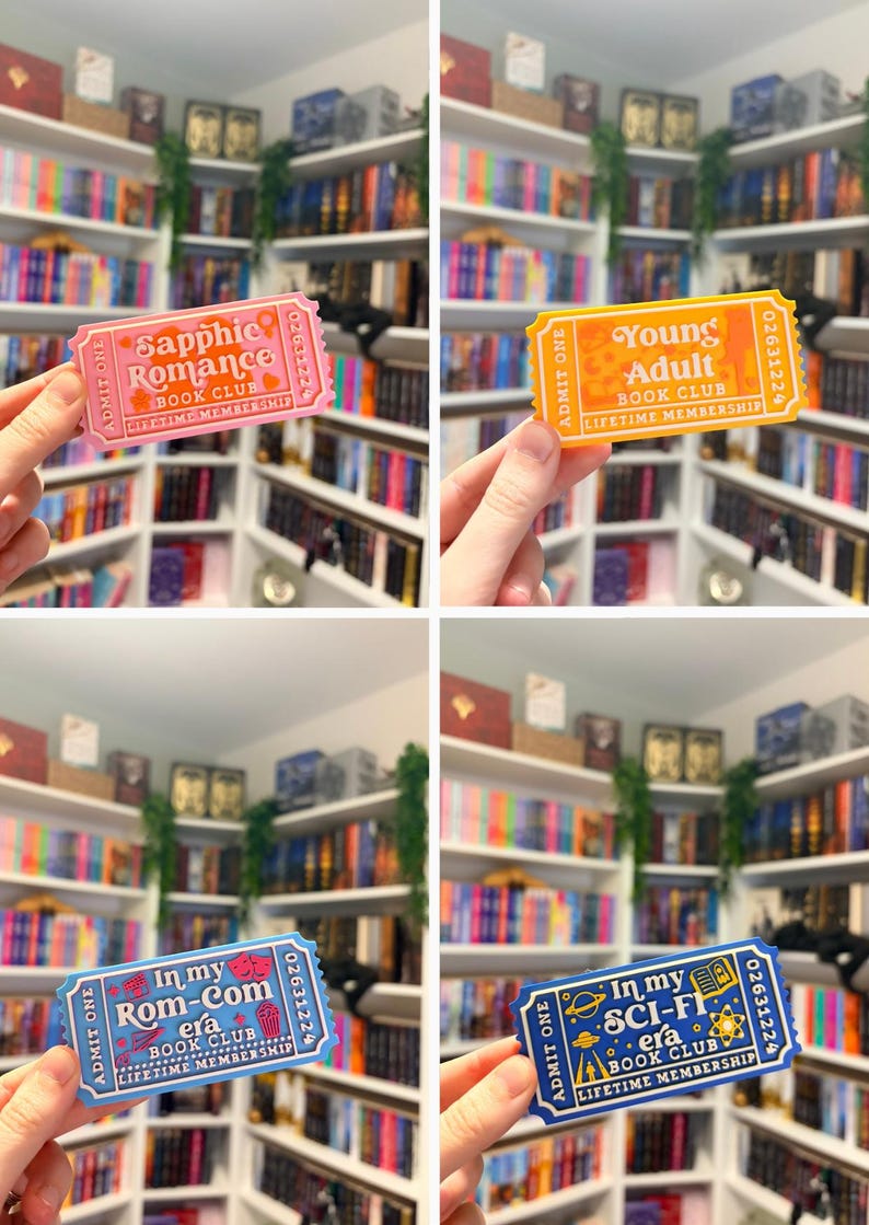 May include: Four rectangular admission ticket-style bookmarks in pink, yellow, light blue, and dark blue. Each features the text "ADMIT ONE," a serial number, and "LIFETIME MEMBERSHIP" with specific genre titles: "Sapphic Romance," "Young Adult," "In my Rom-Com era," and "In my SCI-FI era."