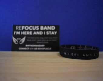 Refocus band: "I'm here and I stay"