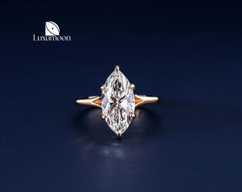 May include: A gold ring with a large, clear marquise-shaped diamond.