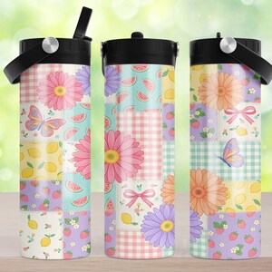 May include: Three cylindrical tumblers with black lids and carrying handles, featuring a patchwork design of pink and purple daisies, butterflies, pink bows, strawberries, lemon slices, watermelon wedges, and pink or green gingham check patterns.