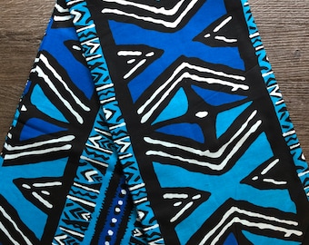 May include: Blue and white fabric with a geometric pattern. The fabric has a black background with white lines and blue triangles.