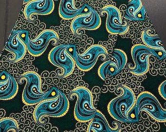 May include: Green fabric with a repeating pattern of blue paisley shapes with gold outlines. The paisley shapes are set against a background of small gold swirls.