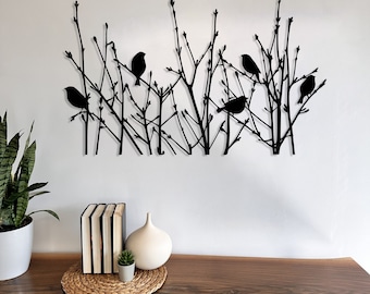 May include: Black metal wall art featuring silhouettes of birds perched on branches. The artwork depicts a stylized forest scene with multiple birds and intricate branch details, suitable for home decor.