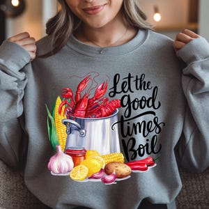 May include: Gray sweatshirt with a graphic of a pot of crawfish and the text "Let the good times boil".