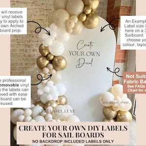 May include: White arched sailboard with the text "Create Your Own Decal". The image features a balloon arch in white, gold, and cream hues. The text indicates the labels are removable vinyl and not suitable for fabric backdrops.