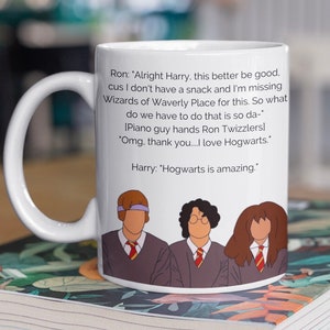 May include: White ceramic mug featuring a quote from Harry Potter with illustrations of Harry, Ron, and Hermione. The mug has a curved handle and is set on a book with a floral design.