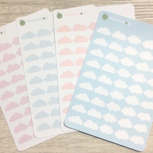 May include: Three sheets of cloud stickers with the word "melancholy" printed on each sheet. The stickers are in pink, light blue, and blue. Each sheet has a grid of white cloud stickers.