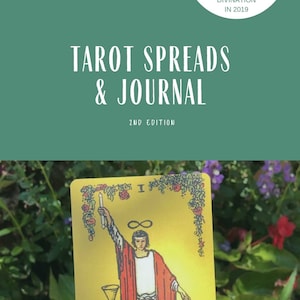 May include: A green background with the text "Tarot Spreads & Journal 2nd Edition" in white. The image also features a tarot card with the image of the Magician, a yellow background, and a floral border. The text "Emerald Lotus Divination" is at the bottom of the image.