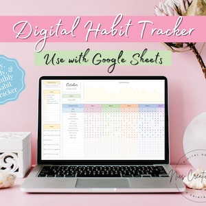 May include: A laptop computer displaying a digital habit tracker spreadsheet on the screen. The spreadsheet is titled "October" and is designed to track daily, weekly, and monthly habits. The text "Use with Google Sheets" is displayed above the spreadsheet. The laptop is sitting on a pink surface with a white box, seashells, and a vase with a dried flower.