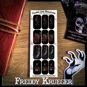 May include: A set of 10 Freddy Krueger nail decals. The decals feature Freddy Krueger's iconic glove, face, and red and green striped sweater. The decals are printed on a white background and are ready to be applied to your nails.