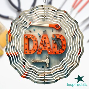 May include: A metal wind chime with the word "DAD" in orange letters surrounded by tools and hardware. The wind chime has a circular shape with multiple layers of metal.