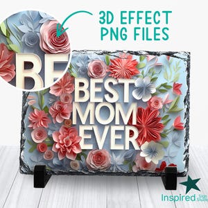 Könnte beinhalten: Eine rechteckige Schieferplatte mit rauen Kanten, die den weißen Text BEST MOM EVER zeigt, umgeben von geschichteten, papierartigen Blumenillustrationen in Rot-, Rosa- und Blautönen. Ein kreisförmiger Ausschnitt zeigt ein Detail mit 3D-Effekt.