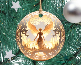 May include: A round, layered Christmas ornament with a detailed angel design. The angel has outstretched wings and is set against a warm, glowing background. The ornament is suspended by a natural twine string and is surrounded by green pine needles and silver star decorations.