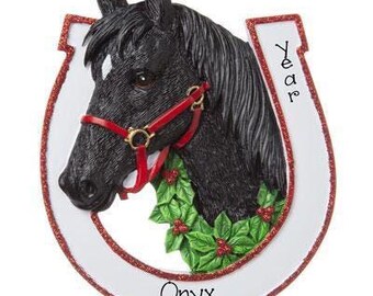 May include: A black horse head ornament framed by a white horseshoe with red glitter edges. The horse wears a red halter and is adorned with green holly leaves and red berries. The text Year is printed on the right side and Onyx at the bottom.