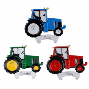 May include: Three tractor ornaments in blue, green, and red. Each tractor features a white banner at the base with the names Mason, Daniel, and Anthony printed in black. The large rear wheels have the word year printed in black on the center hub.
