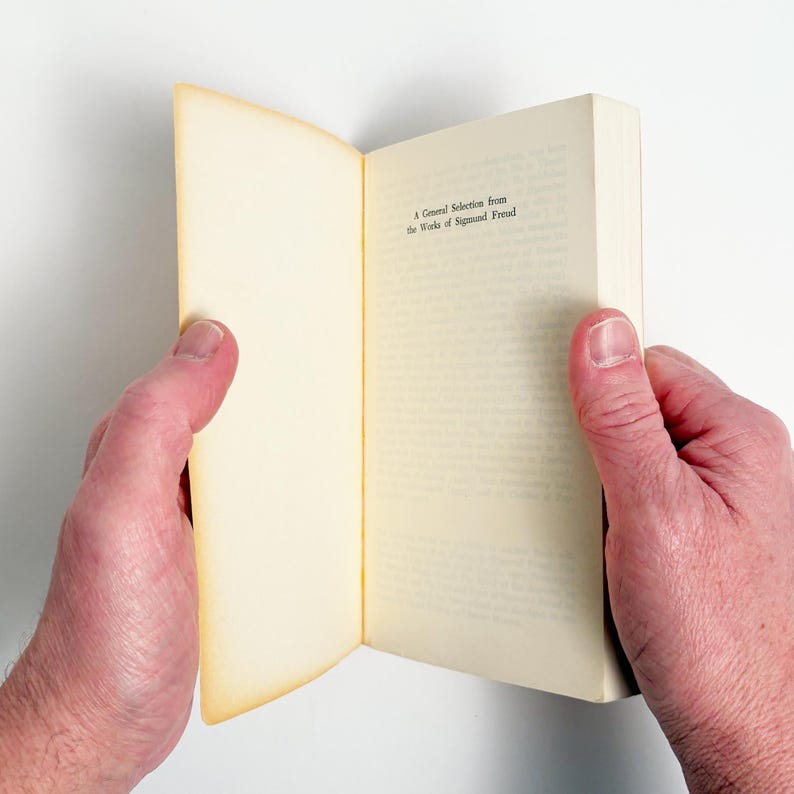 May include: A white ceramic mug with a black handle and the text "But First, Coffee" in a black, handwritten-style font. The mug is on a white surface.