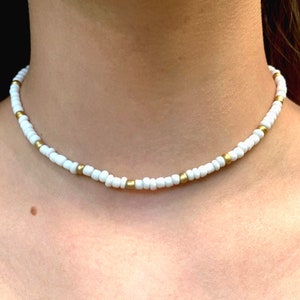 White and gold chocker necklace.
