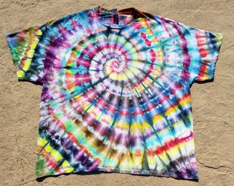 May include: A tie-dye t-shirt with a colorful spiral pattern in shades of blue, green, yellow, red, purple, and black.