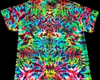 May include: A tie-dye t-shirt with a colorful, abstract pattern in shades of blue, green, red, yellow, and purple. The pattern is symmetrical and resembles a mandala.