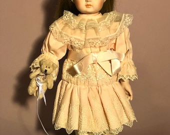 porcelain doll with teddy bear