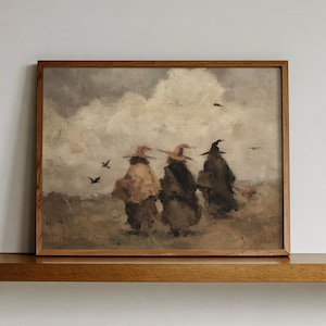 May include: A rectangular framed wall art print featuring an oil painting of three figures wearing pointed hats and cloaks walking across a field under a cloudy sky. The figures are depicted in muted brown and grey tones with small birds flying.