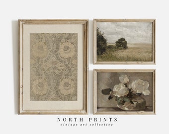 May include: Three framed vintage art prints in a light wood frame. The prints are of a floral pattern, a landscape with a tree in a field, and a still life of white flowers in a vase.