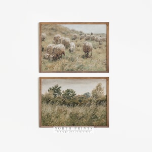 May include: Two framed vintage landscape paintings. The top painting shows a flock of sheep grazing in a field. The bottom painting shows a field of tall grass with trees and a house in the distance.