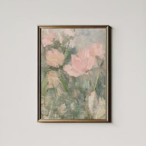 May include: A framed floral oil painting featuring soft pink flowers with yellow centers against a backdrop of green and blue hues. The artwork is enclosed in a gold-colored frame, creating a vintage aesthetic.