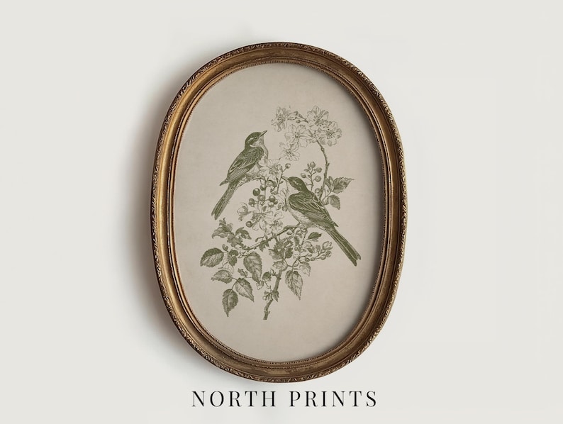 May include: An oval framed print featuring two birds perched on a flowering branch. The birds and foliage are rendered in shades of green against a beige background. The frame is gold-toned, and the text "NORTH PRINTS" is at the bottom.