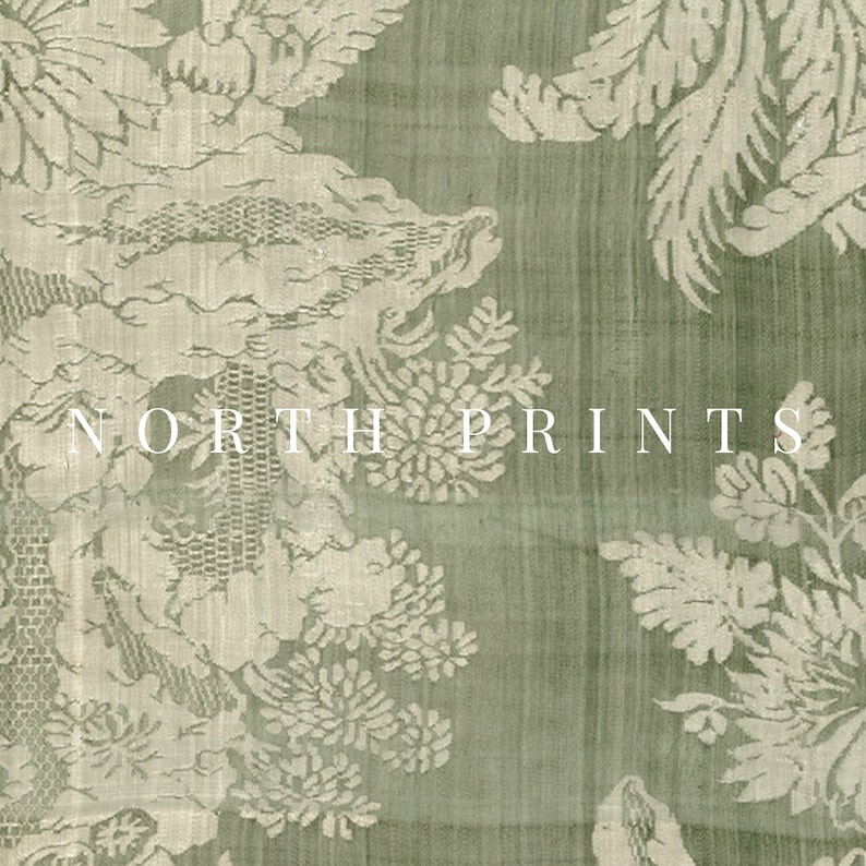 May include: A green fabric with a white floral pattern. The fabric has a subtle sheen and a textured surface. The text "NORTH PRINTS" is printed in white on the fabric.