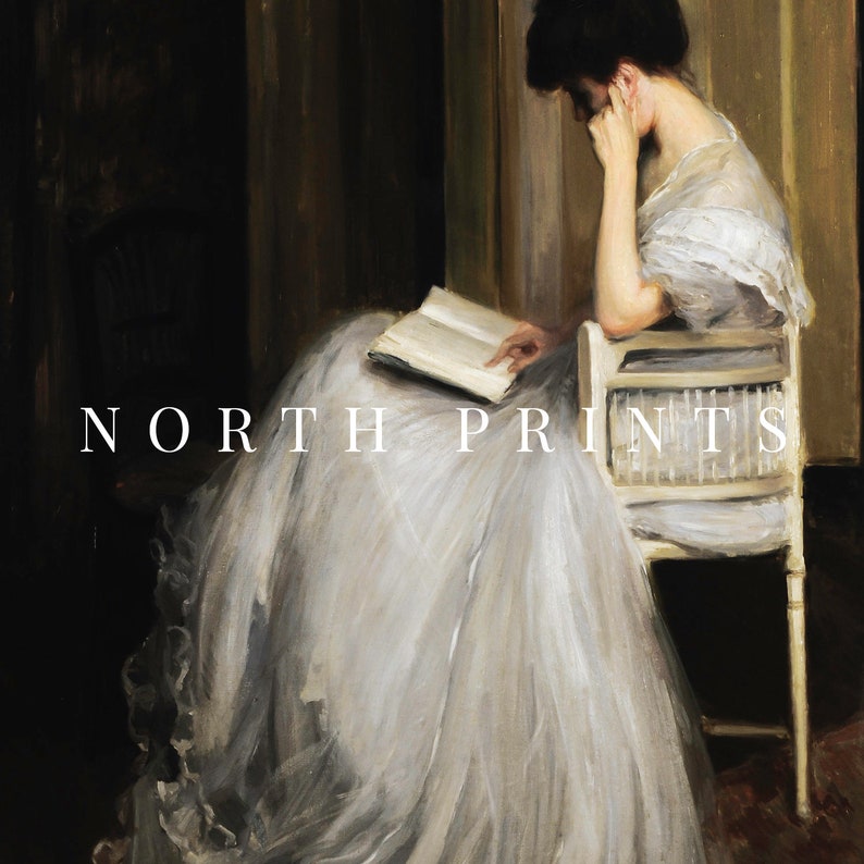 May include: A woman in a white dress sits in a chair and reads a book. The chair is made of wood and has a white wicker back. The woman's dress is flowing and has a lot of fabric. The background is a dark brown color.