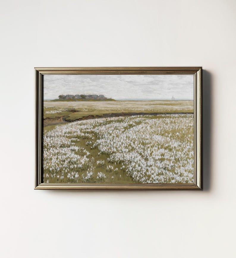 May include: A framed painting depicting a field of white flowers in a landscape setting. The flowers are in the foreground, with a distant view of a small town or village in the background. The sky is a light gray, and the overall tone of the painting is serene and peaceful.