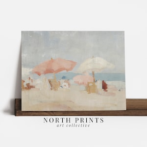 Puede incluir: Una pintura de escena de playa con cielo y oc&eacute;ano azul claro. Dos sombrillas rosas y una blanca dan sombra a la orilla arenosa. La obra de arte incluye el texto "NORTH PRINTS art collective".